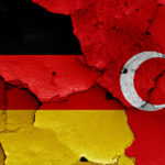 flags of Germany and Turkey painted on cracked wall